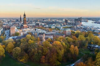 Hotel Atlantic View of Hamburg with Michel, harbor, and New Elbphilharmony on sunset in autumn.