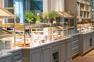 Buffet mit frischen Speisen, Kräutern und eleganter Präsentation in einem stilvollen Restaurant.